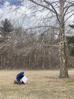 adam looking in a bag outside